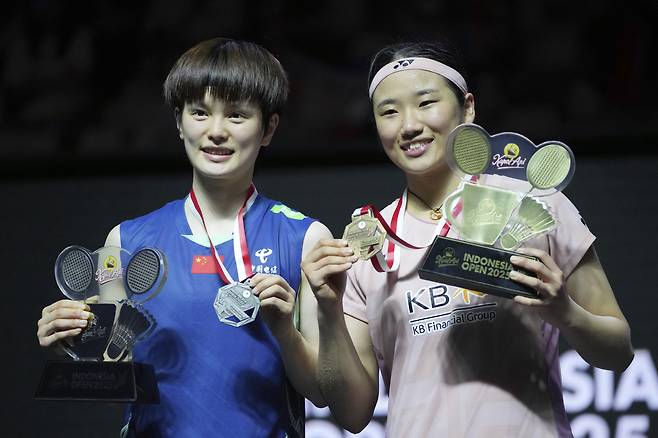 First place winner South Korea's An Se Young, right, celebrates on the podium after defeating China's Wang Zhiyi, left, in their women's singles final match at the Indonesia Open badminton tournament at Istora Stadium in Jakarta, Indonesia, Sunday, June 8, 2025. (AP Photo/Achmad Ibrahim)<저작권자(c) 연합뉴스, 무단 전재-재배포, AI 학습 및 활용 금지>