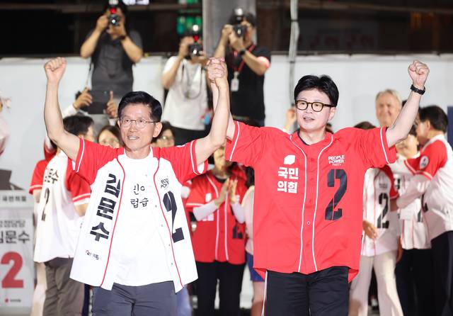 김문수 전 국민의힘 대선 후보가 지난 2일 서울시청 앞 서울광장에서 열린 피날레 유세에서 한동훈 전 대표의 손을 잡고 지지를 호소하고 있다. 연합뉴스