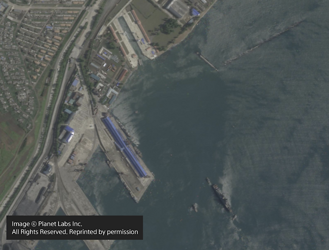 북한 구축함이 예인선 세 대와 함께 북상하고 있다. 사진 우측 하단