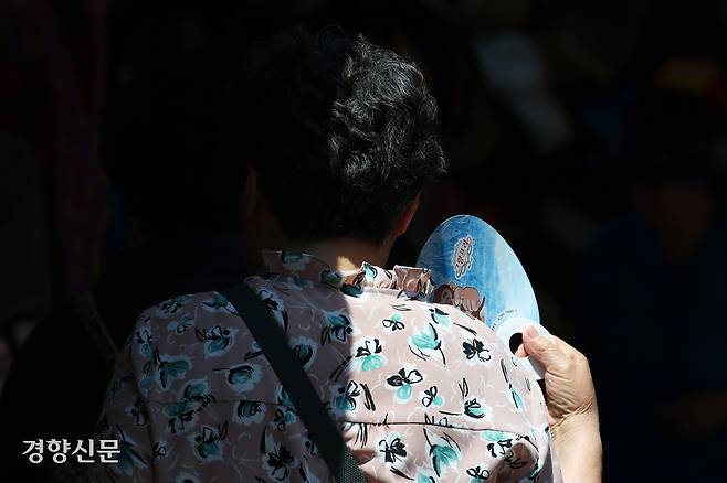 전국적으로 무더운 날씨를 보인 23일 서울 중구 남대문시장을 찾은 시민이 부채질하고 있다. 정효진 기자