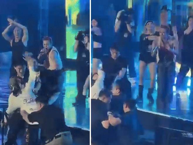 지난 21일(현지시간) 베트남 하노이의 미딘 국립경기장에서 열린 'K-STAR SPARK IN VIETNAM 2025'에서 무대를 펼치던 가수 지드래곤이 난입한 관객을 바라보며 미소짓고 있다. /사진=엑스 갈무리