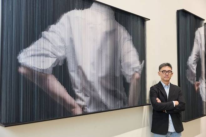 홍성철 작가가 자신의 작품 'String_mirror_0942'(2022)에 서서 촬영에 응하고 있다. 프레인글로벌