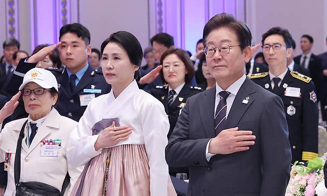 이재명 대통령과 김혜경 여사가 27일 청와대 영빈관에서 열린 '호국 보훈의 달, 대통령의 초대' 행사에서 국기에 경례하고 있다. 이번 행사에는 국가유공자 및 유족, 보훈단체장, 특별초청자 등이 참석했다. 연합뉴스