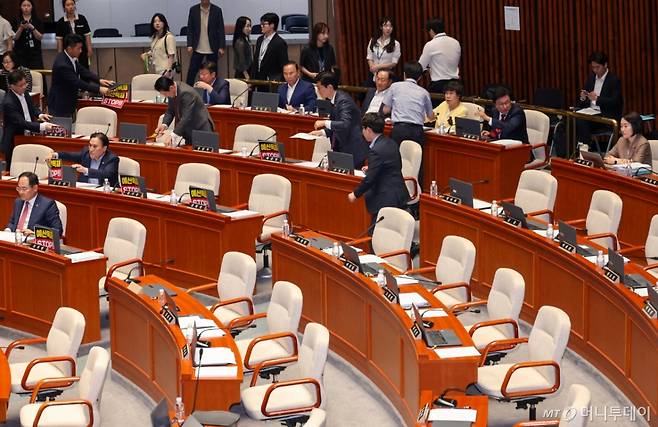 (서울=뉴스1) 안은나 기자 = 국민의힘 박형수 간사와 의원들이 30일 오후 서울 여의도 국회에서 열린 제426회국회(임시회) 예산결산특별위원회 제1차 전체회의에서 의원석에 '예산독재 STOP'이라고 적힌 피켓을 떼어내고 있다. 여야가 이재명 정부 첫 추경안 심사를 위한 예결위 종합정책질의를 이틀간 진행하기로 합의함에 따라 이날 오전 회의를 보이콧했던 국민의힘은 오후 질의에 참석했다. 2025.6.30/뉴스1 Copyright (C) 뉴스1. All rights reserved. 무단 전재 및 재배포, AI학습 이용 금지. /사진=(서울=뉴스1) 안은나 기자