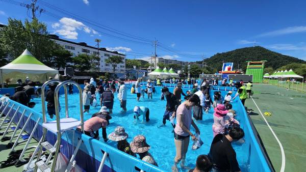 가족 단위 방문객들이 은어 맨손잡이 체험을 하고 있다.