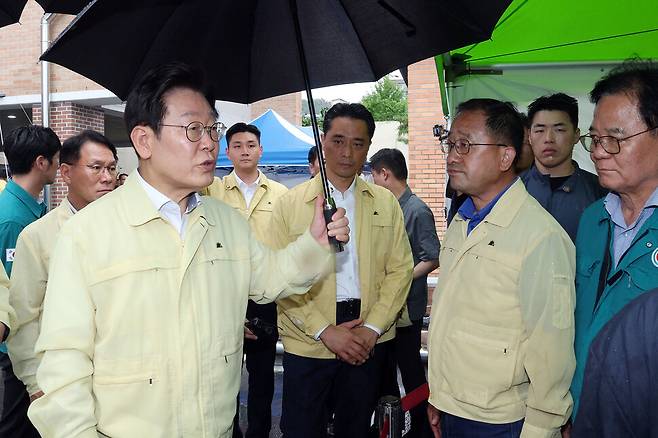 이재명 대통령이 21일 경남 산청군 산청읍 행정복지센터 인근에 마련된 호우 피해 통합지원본부에서 피해 현황 보고를 받은 뒤 피해 현장으로 이동고 있다. 연합뉴스.