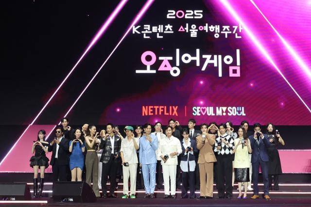 넷플릭스 시리즈 '오징어 게임'의 황동혁(왼쪽 여섯 번째) 감독, 배우 이정재와 이병헌 등이 6월 28일 서울 중구 서울광장에서 열린 팬 이벤트 행사에서 기념 촬영을 하고 있다. 뉴시스