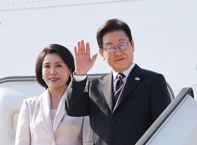 한일 정상회담을 마친 이재명 대통령과 부인 김혜경 여사가 24일 일본 도쿄 하네다공항에서 도널드 트럼프 미국 대통령과의 한미 정상회담을 위해 워싱턴DC로 향하며 공군1호기에 올라 인사하고 있다. 연합뉴스
