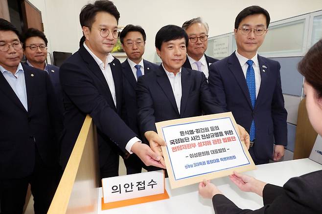 더불어민주당 3대 특검 종합대응 특별위원회 소속 의원들이 18일 국회 의안과에 '윤석열·김건희 등의 국정농단 사건 진상규명을 위한 전담재판부 설치에 관한 법률안'을 제출하고 있다. 앞줄 오른쪽부터 장경태·이성윤·전용기 의원. 한주형 기자