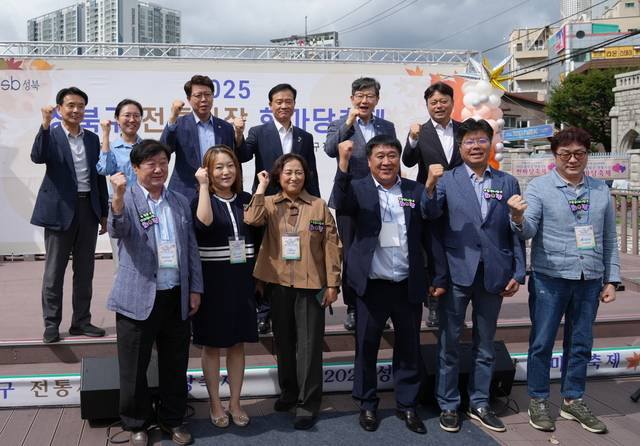 이승로 성북구청장(뒷줄 왼쪽 네 번째)과 관계자들이 성북구청 앞 바람마당에서 열린 ‘2025년 성북구 전통시장 한마당 축제’를 기념해 사진 촬영을 하고 있다. 성북구청 제공