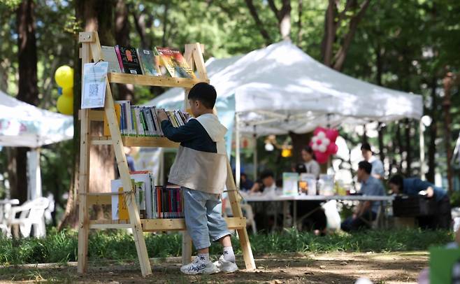 지난 21일 서울 강남구 도산공원에서 '가족숲속도서관' 행사가 열려 야외 팝업 도서관이 운영되는 모습./ 사진 = 뉴시스