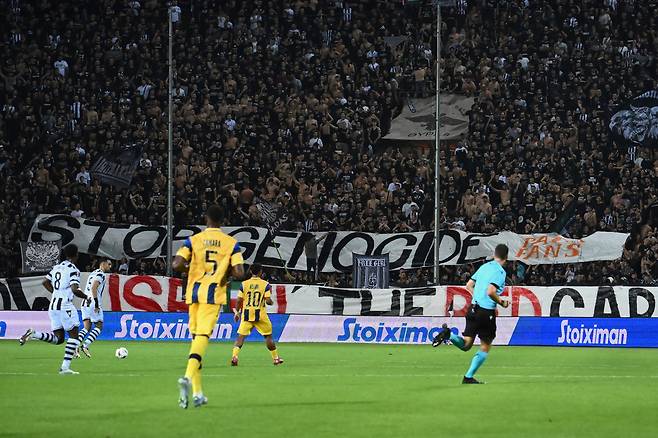 지난 25일 그리스에서 열린 유로파리그 경기 도중 PAOK 팬들이 ‘학살을 멈춰라(Stop genocide)’라고 적힌 현수막을 펼치고 있다. 상대는 이스라엘의 마카비 텔아비브였다. AP