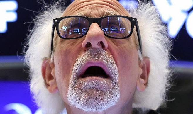 뉴욕증권거래소에서 트레이더가 전광판을 바라보고 있다. (사진=AFP)