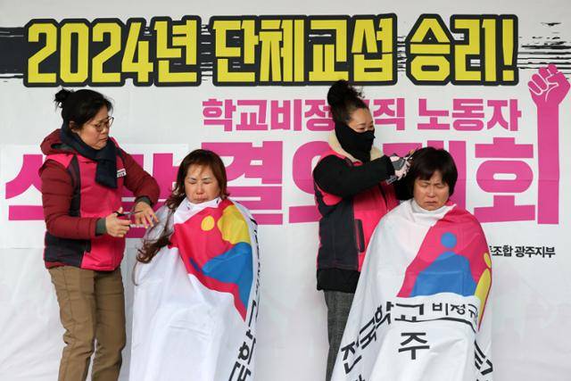3일 광주 서구 광주시교육청 본관 앞에서 단체교섭 타결을 촉구하면서, 삭발식에 나선 학교 비정규직 노동자들이 눈을 질끈 감고 울먹이고 있다. 급식노동자, 돌봄전담사, 특수교육실무사 등으로 구성된 전국학교비정규직연대회의는 저임금을 유발하는 방학 중 무임금, 최저임금 이하 기본급, 명절 휴가비 차별 해소 등을 요구하고 있다. 연합뉴스