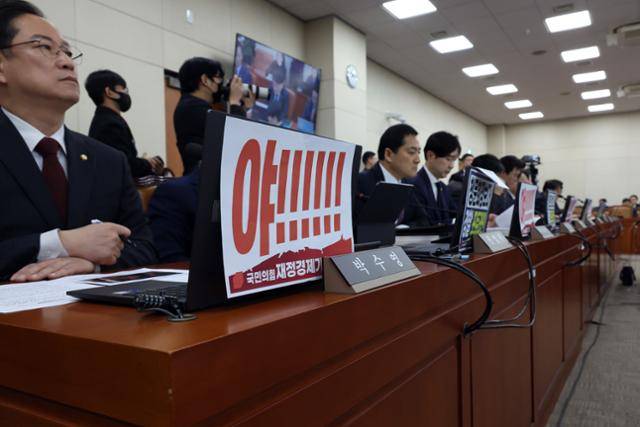 박수영 의원 등 국민의힘 재정경제기획위원들이 23일 국회에서 열린 이혜훈 기획예산처 장관 후보자 인사청문회에서 후보자 비판 피켓을 노트북에 붙여놓고 있다. 뉴시스