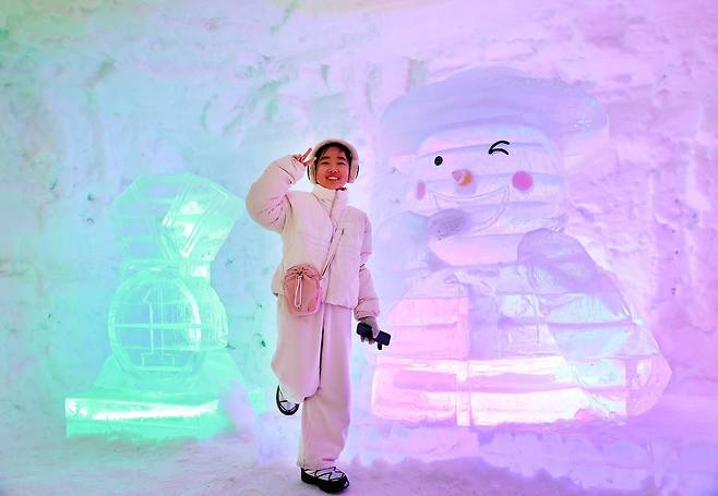 강원도 평창군 대관령면 횡계리 송천 일대 축제장에서 열린 제34회 평창 대관령눈꽃축제를 찾은 어린이가 얼은조각을 배경으로 기념사진을 촬영하고 있다.평창관광문화재단 제공