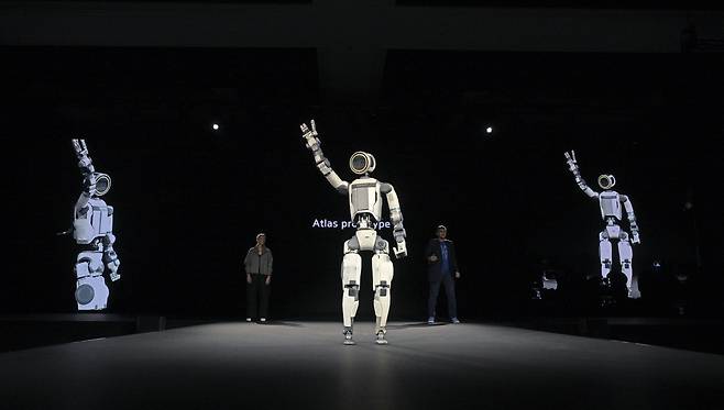 Aya Durbin, humanoid application product lead at Boston Dynamics (left) and Zachary Jackowski, vice president and general manager of Atlas at Boston Dynamics, introduce the humanoid robot Atlas at CES 2026 in Las Vegas in January. (Hyundai Motor Group)