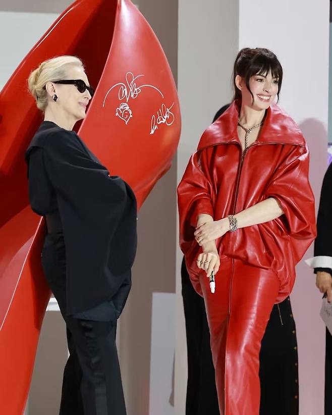 서울 프리미어에서 앤 헤서웨이는 발렌시아가의 레드 가죽 드레스를, 메릴 스트립은 셀린느의 사선 슬리브 톱과 팬츠의 셋업을 입었다. @tdwp2