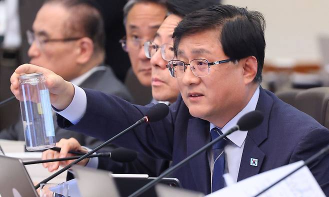 김성환 기후에너지환경부 장관이 28일 청와대에서 열린 국무회의 겸 비상경제점검회의에서 이재명 대통령에게 PET캔(캔시머) 용기를 설명하고 있다. 연합뉴스