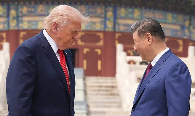 President Donald Trump, left, stands beside Chinese President Xi Jinping at the Temple of Heaven on Thursday May 14, 2026, in Beijing. (AP Photo/Mark Schiefelbein)