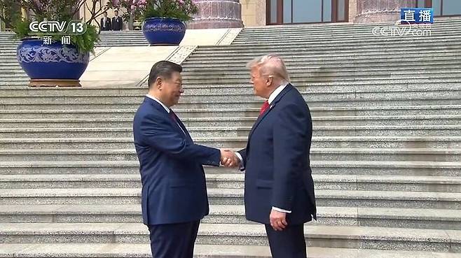 도널드 트럼프 미국 대통령이 14일 오전 10시 3분쯤 베이징 인민대회당에서 시진핑 중국 국가주석을 만나 악수하고 있다. /중국 중앙(CC)TV 캡처