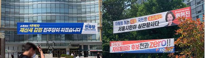 서울 송파구 잠실역 네거리 양쪽 길가에 ‘부동산 세금’ 이슈를 다룬 더불어민주당(왼쪽)과 국민의힘 플래카드가 걸려 있다.