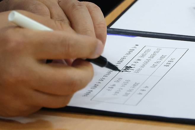 여명구 삼성전자 DS(디바이스솔루션·반도체 사업 담당) 피플팀장이 20일 오후 경기 수원시 장안구 경기지방고용노동청에서 열린 삼성전자 노사교섭 결과 브리핑에서 합의안에 서명을 하고 있다. 2026.05.20 양회성 기자 yohan@donga.com