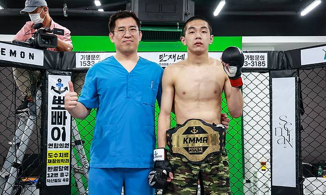 KMMA 플라이급 챔피언 문순수(오른쪽)가 경기에서 승리한 후 메인 스폰서 겸 에이전시 대표 김성배 대표원장과 기념사진을 찍고 있다. 뽀빠이연합의원KMMA파이터에이전시 제공
