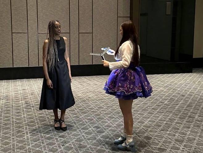 Mini, a TikTok creator whose real name is Kim Ha-min, films content with Fatou of Blackswan at Africa Day 2026, hosted by the African Group of Ambassadors in the Republic of Korea, The Korea Herald and the Korea-Africa Foundation in Seoul, Wednesday. (TikTok Korea)
