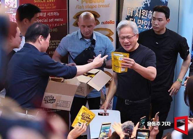 젠슨 황 엔비디아 최고경영자(CEO)가 5일 서울 마포구 서교동의 한 고깃집에서 최태원 SK회장, 구광모 LG회장, 이해진 네이버 의장과 삼겹살 회동 도중 최 회장에게 SK하이닉스 HBM칩을 선물 받고 있다. 2026.06.05 윤동주 기자