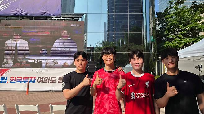 2026 북중미 월드컵 1차전이 열리는 12일 오전 서울 영등포구 한국투자증권 본사 앞 거리 응원장에서 대학생 연제훈(23)씨와 친구들이 국가대표팀에 응원을 보내고 있다. 이규림 기자