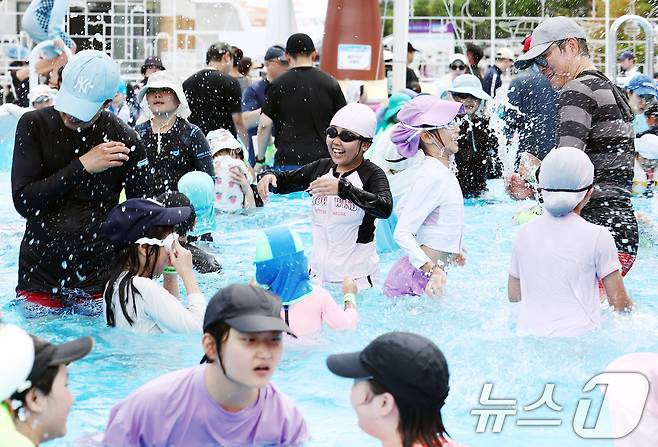 무더운 날씨를 보인 26일 오후 서울 종로구 광화문광장에 마련된 2026 서울썸머비치 수영장에서 시민들이 물놀이를 하며 즐거운 시간을 보내고 있다. 2026.7.26 ⓒ 뉴스1 김민지 기자