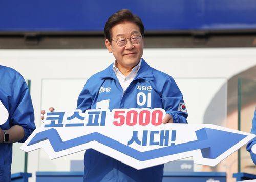 더불어민주당 당시 이재명 대선후보가 지난해 5월29일 서울 서초구 고속버스터미널 앞에서 열린 서초구·강남구 유세에서 '코스피 5000 시대'를 들어 보이며 경제회복 퍼포먼스를 하고 있다. 연합뉴스