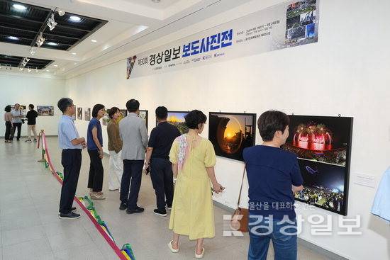 ▲ 19일 울산문화예술회관 제4전시장에서 열린 제30회 경상일보 보도사진전에서 관람객들이 사진을 감상하고 있다.