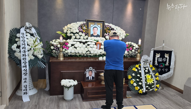 지난 8월 28일 천안 대원산업 화재로 숨진 필리핀 이주노동자 조이 칸토 씨의 동생(40)이 형의 영정 앞에서 고개를 숙이고 있다. (10월 4일 촬영)